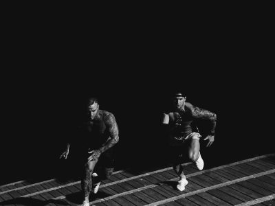 grayscale photo of two men racing each other