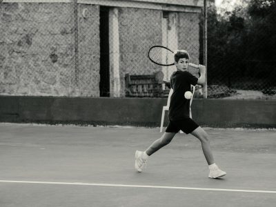 a man holding a tennis racquet on a tennis court